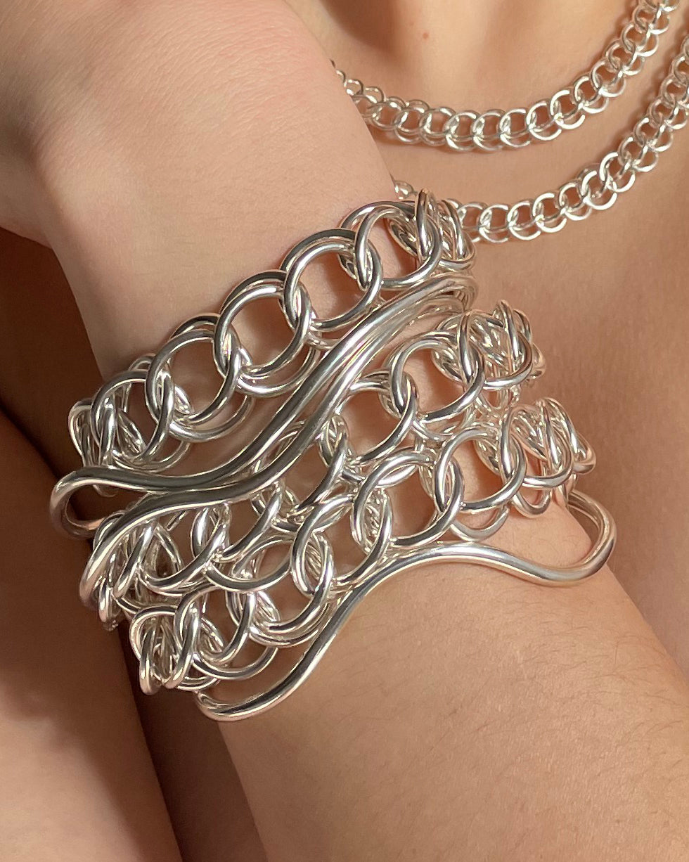 Layering Flow bangle with the Orbit bracelet and the Sundial chain necklaces. All in sterling silver